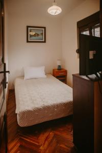 a small bedroom with a bed and a television at Apartments Azure Adriatic in Kotor