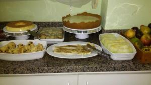 a counter top with different types of food on it at Pousada Estrela do Mar Angra dos Reis in Angra dos Reis