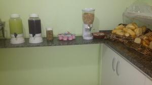 a kitchen counter with some food and drinks on it at Pousada Estrela do Mar Angra dos Reis in Angra dos Reis