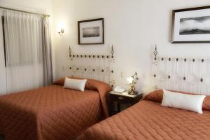 um quarto de hotel com duas camas e uma janela em El Meson de los Poetas em Guanajuato