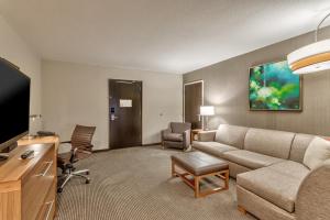 a living room with a couch and a flat screen tv at Hyatt Place Minneapolis/Downtown in Minneapolis
