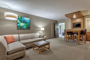 a living room with a couch and a table at Hyatt Place Minneapolis/Downtown in Minneapolis