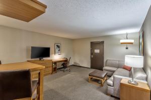 a hotel room with a desk and a tv at Hyatt Place Minneapolis/Downtown in Minneapolis