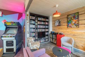 a room with a video game in a library at Back to the 80'S in Saint-Égrève +9 photos