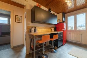 a kitchen with a counter and a red refrigerator at Back to the 80'S in Saint-Égrève