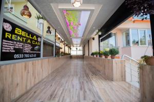 a hallway of a restaurant with a wooden floor and a ceiling at Melodi Hotel in Isparta