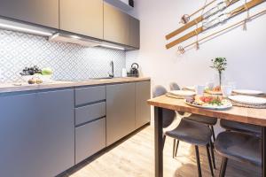 a kitchen with a table and a dining room at Apartament "Nosal" Droga na bystre Zakopane in Zakopane