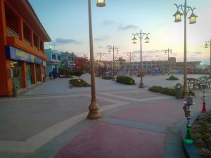 a city street with street lights on a sidewalk at شاليهات بورتو مطروح فيو بحر Porto Matrouh Sea View Families Only in Marsa Matruh