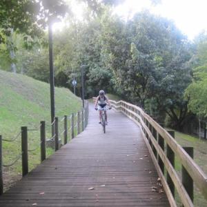 a person riding a bike on a bridge at Hotel Portofoz in Porto