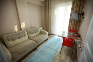 a living room with a couch and a table at Bella Suit Apart Hotel in Isparta