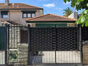 an iron fence in front of a house at La MagnoliaII in Mar del Plata