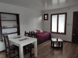 a living room with a table and a couch at La MagnoliaII zona Güemes in Mar del Plata