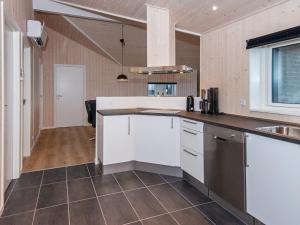 een keuken met witte kasten en een aanrecht bij 8 person holiday home in Henne in Henne Strand