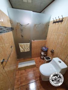 a bathroom with a toilet and a shower at Black Snapper House in Golfito