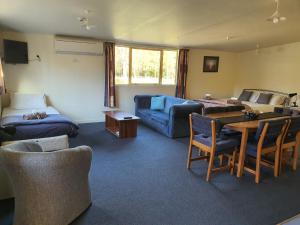 a living room with a couch and a table at Hanmer Springs Forest Camp Trust in Hanmer Springs