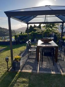 a table and chairs under a blue umbrella at rooms with a view in Haywards