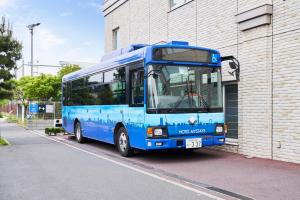 a blue bus parked next to a building at MYSTAYS Shin Urayasu Conference Center in Urayasu