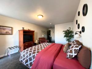 a bedroom with a large bed with a giraffe blanket at Roundtop Mountain Vista - Cabins and Motel in Thermopolis