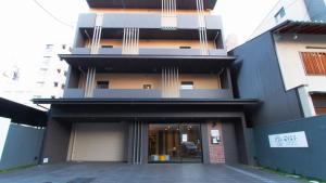 a building with the front entrance of a building at Meldia Stay Omiya KARIGANE in Kyoto
