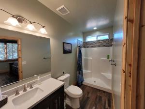 a bathroom with a toilet and a sink and a mirror at East Zion Trails Retreat-Hot tub, Resort Amenities, Exceptional in Orderville +41 photos