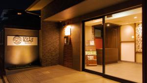 a store front with glass doors in a building at Meldia Stay Nijojo IWAGAMI in Kyoto