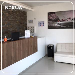 a waiting room with a counter and a couch at Nakua Paracas Lodge in Paracas