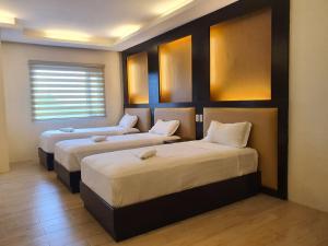 a room with two beds in a room at Northpointe Residences in Manila