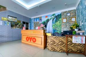 a shop with a ovo sign on the wall at Super OYO 90039 Coop Hotel Kangar in Kangar