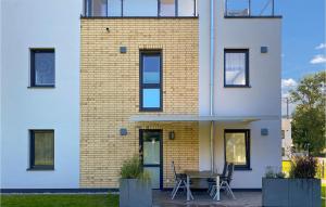 a building with a table and chairs in front of it at 2 Bedroom Cozy Apartment In Rechlin in Rechlin +13 photos