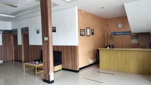 a lobby with a reception desk in a building at De' Premium Hotel Musi Raya in Sukarami