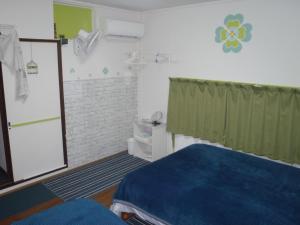 Ένα ή περισσότερα κρεβάτια σε δωμάτιο στο Mike's B&B Tokoname