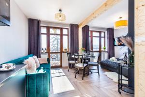 a living room with a couch and a table at Apartamenty na Leśnej in Bukowina Tatrzańska