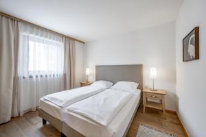 Posteľ alebo postele v izbe v ubytovaní Apartment Torri di Seefeld