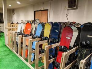 a row of snowboards lined up in a rack at Hotel Madam Mirei in Iiyama