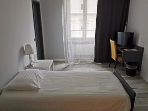 Voodi või voodid majutusasutuse Hotel Fleur-de-Lys toas