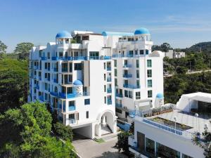 a white building with blue domes on top of it at Costa Beach Residence & Jacuzzi in Sattahip