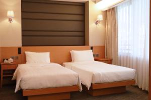 Postel nebo postele na pokoji v ubytování South Pacific Hotel