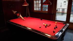 a woman is playing pool on a pool table at Hart van Bourdonck in Boerdonk