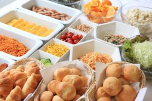 a bunch of containers of different types of food at Smile Hotel Shin-osaka in Osaka
