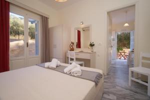 a bedroom with a large bed with towels on it at Prince Studios in Sami