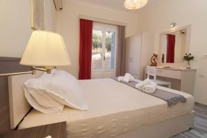 a bedroom with a large bed with a lamp on it at Prince Studios in Sami