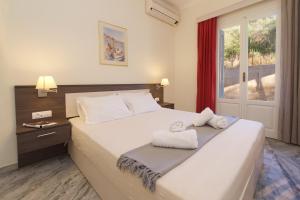 a bedroom with a bed with towels on it at Prince Studios in Sami