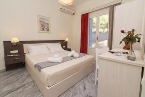 a bedroom with a bed with towels on it at Prince Studios in Sami