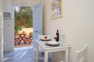 a dining room with a white table and wine glasses at Prince Studios in Sami