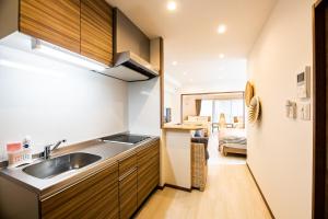 a kitchen with a sink and a counter top at Tomariehotel & condominium in Fukuoka +21 photos