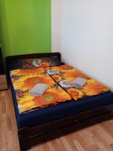 a bed with a colorful comforter in a room at Domek in Reľov