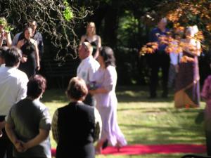 a bride and groom are standing in the grass at Burnbank in Berwick