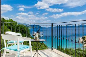 balkon ze stołem i krzesłami oraz oceanem w obiekcie Villa Sofija Dubrovnik & Peljesac Region w mieście Slano