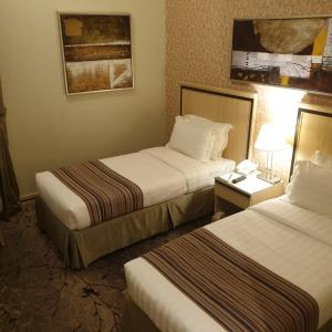 Al Massa Hotel Makkah tesisinde bir odada yatak veya yataklar