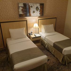 Un pat sau paturi într-o cameră la Al Massa Hotel Makkah